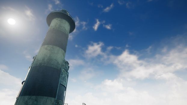 Old Lighthouse at sunrise on the background of the sea