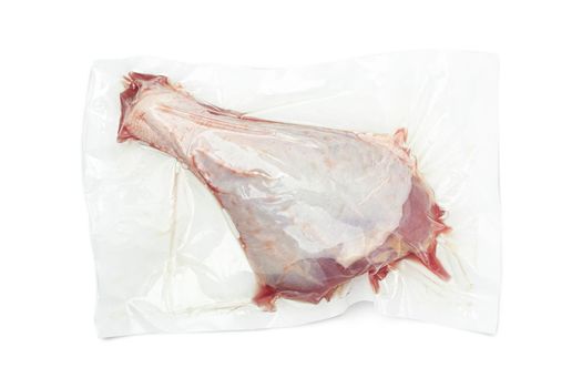 Vacuum packed turkey meat isolated on white background. Raw drumstick. With clippig path