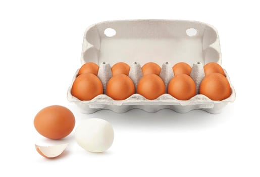 Open egg box with ten brown eggs isolated on white background. Fresh organic chicken eggs in carton pack or egg container with copy space