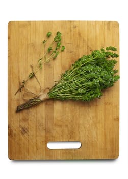 Thyme Bush on the cutting Board isolated on white background. With clipping path.