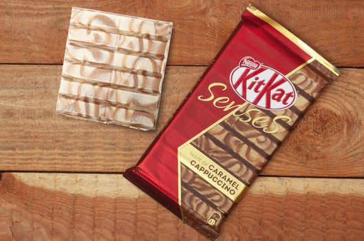 CHISINAU, MOLDOVA - April, 26, 2020: Nestle KitKat chocolate bar, biscuit, break. Isolated on wooden background