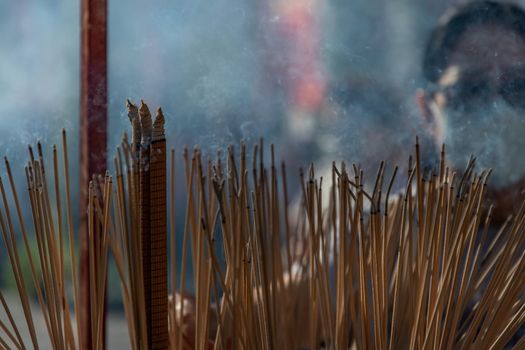 Bangkok, Thailand - 16 Feb 2020 : Incense burning with white smoke in an incense pot at a temple in Wat Mangkon Kamalawat. There is a lot of smoke. Selective focus.