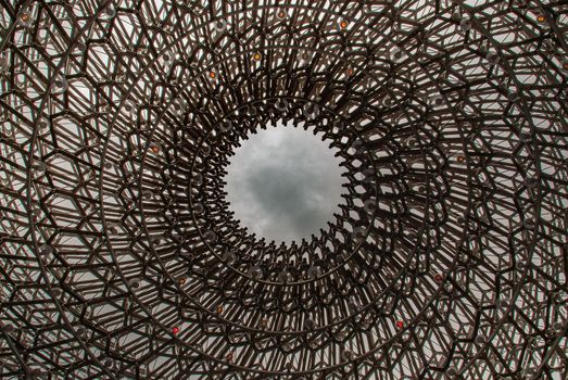 London, UK - Apr 9, 2019 : Detail on the center of the intricate structure under a clear sky, It is called "The Hive" Designed by Artist Wolfgang Buttress.