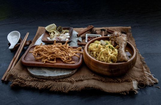 Northern Style Curried Noodle Soup with coconut milk (Khao soi), Traditional of Northern Thai cuisine, Oblique view from the top.