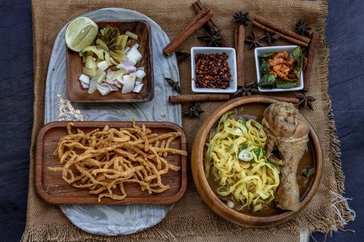 Northern Style Curried Noodle Soup with coconut milk (Khao soi), Traditional of Northern Thai cuisine, Top view.