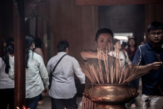 Bangkok, Thailand - 27 Oct 2019 : Interesting Asian women experience Thailand religion culture praying at Dragon Temple Kammalawat (Wat Lengnoeiyi), Wat Leng Noei Yi is the most important Chinese Buddhist temple in Bangkok.