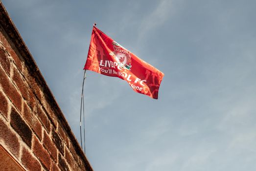 Liverpool - England - April 13, 2019: Liverpool F.C. Flag waving with the blue sky background.