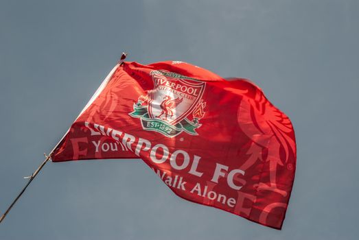 Liverpool - England - April 13, 2019: Liverpool F.C. Flag waving with the blue sky background.