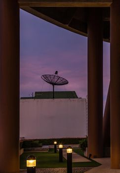 Black Satellite Dish Antenna Receiver Against on Blue Sky background  for Communication and Media Industry, Symbolizing Global Communications. Selective focus.