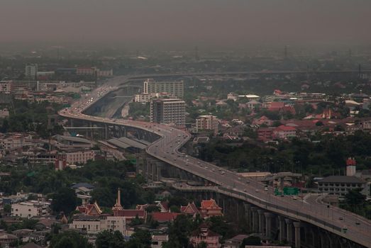 Bangkok, Thailand - Oct 05, 2019 : Aerial view of cars driving on highway junctions. Bridge roads with green garden and trees in connection of architecture concept. Top view. Urban city.
