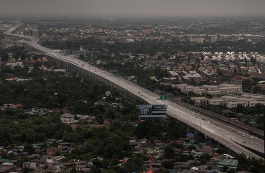 Bangkok, Thailand - Oct 05, 2019 : Aerial view of cars driving on highway junctions. Bridge roads with green garden and trees in connection of architecture concept. Top view. Urban city.