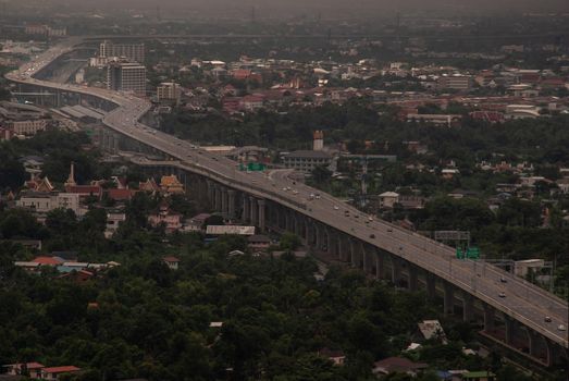 Bangkok, Thailand - Oct 05, 2019 : Aerial view of cars driving on highway junctions. Bridge roads with green garden and trees in connection of architecture concept. Top view. Urban city.