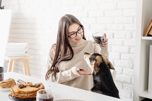 Alternative coffee brewing. Young brunette woman drinking hot black coffee sitting at the white table