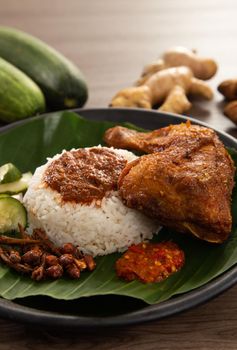 Nasi Kukus is usually comprising freshly steamed rice, crispy fried chicken, sambal belacan, acar and a curry gravy