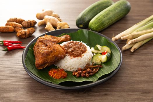 Nasi Kukus is usually comprising freshly steamed rice, crispy fried chicken, sambal belacan, acar and a curry gravy