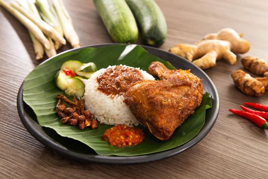 Nasi Kukus is usually comprising freshly steamed rice, crispy fried chicken, sambal belacan, acar and a curry gravy