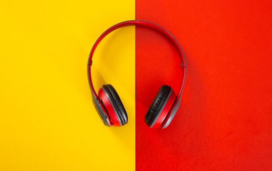 headphones on red and yellow  background. Music concept.