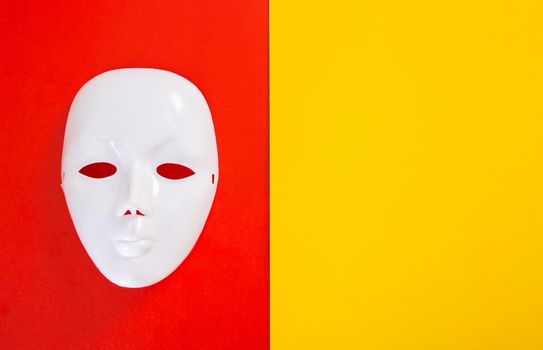 carnival white mask on red and yellow background