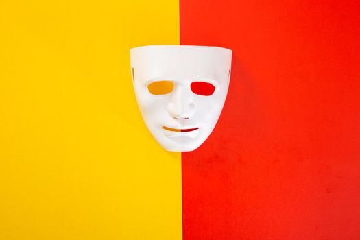 carnival white mask on red and yellow background
