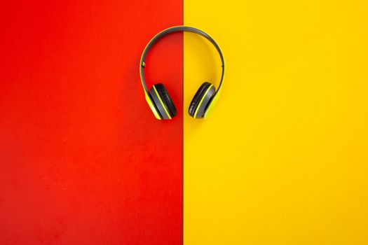 headphones on red and yellow  background. Music concept.