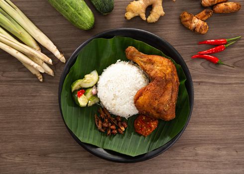 Nasi Kukus is usually comprising freshly steamed rice, crispy fried chicken, sambal belacan, acar and a curry gravy