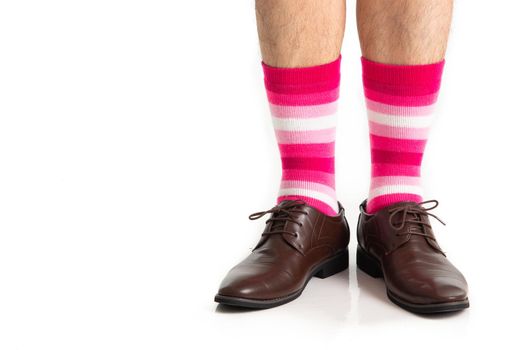 Men's feet in stylish shoes and funny socks isolated on white background