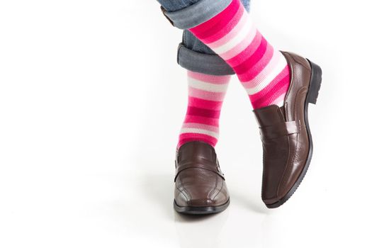 Men's feet in stylish shoes and funny socks isolated on white background