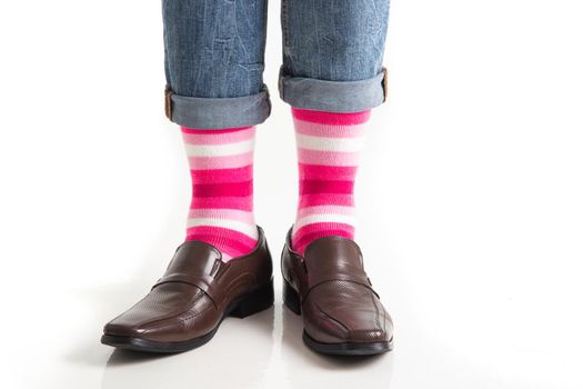 Men's feet in stylish shoes and funny socks isolated on white background