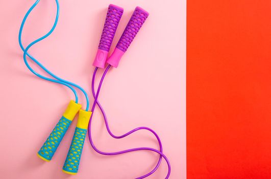 Minimalism fitness concept. Skipping rope on color background. Top view