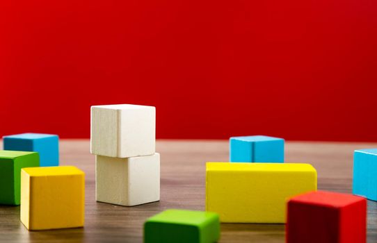 color wooden block on wooden table with red background