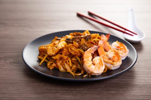 A delicious spicy fried flat rice noodle also know as "char kuew teow" that is famous among Malaysian.