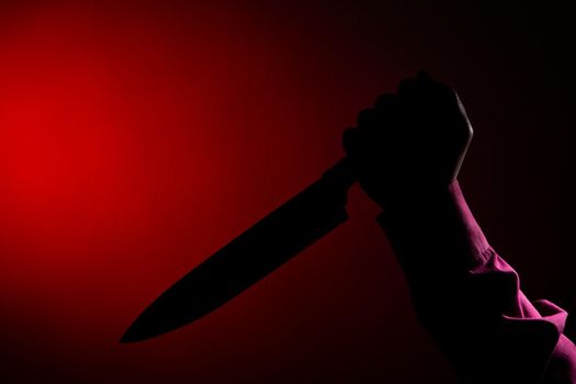 Murderer with big knife in hand of scary crime scene, Silhouette style