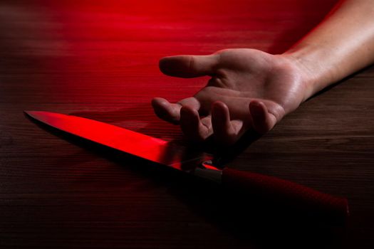 man's body on the floor with big knife. Concept photo of murder and crime