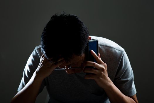 Sad and depressed man received a bad news from his phone - Feeling depressed background concept