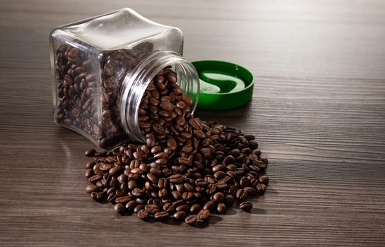coffee beans in the glass jar on dark background