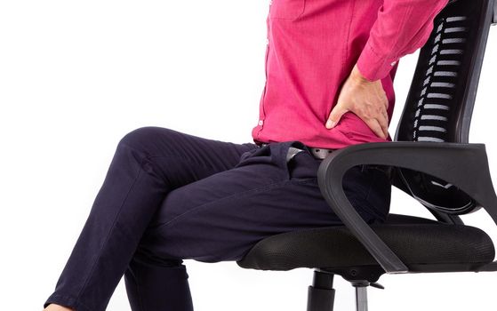 Business man with back pain sitting in an office chair. Pain relief concept