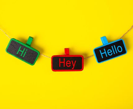 Color tag with the word HI, HEY and HELLO on yellow background