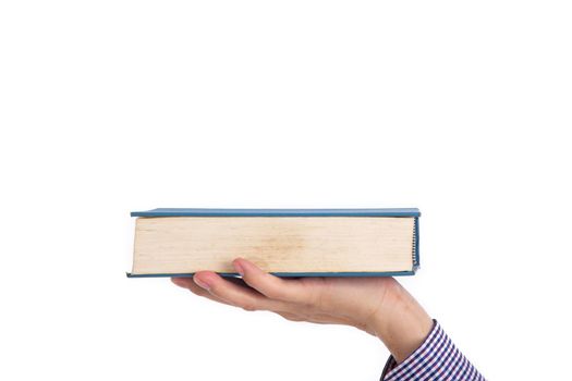 Male hand holding a book isolated on a white background,