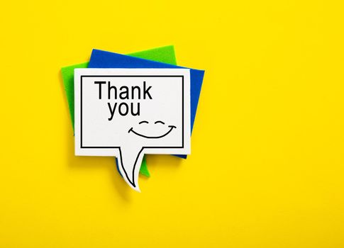 colorful speech bubble written with Thank You on yellow background