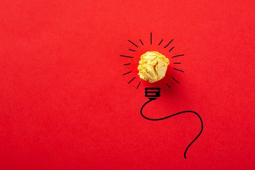 Creative idea, Inspiration, New idea and Innovation concept with Crumpled Paper light bulb on red background.
