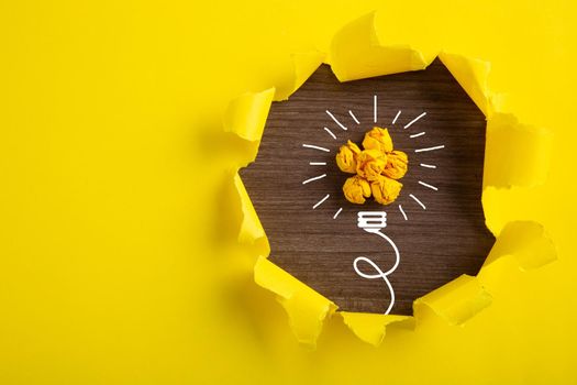 Creative idea, Inspiration, New idea and Innovation concept with Crumpled Paper light bulb on yellow background.