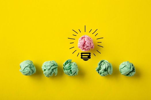 Inspiration concept crumpled paper light bulb metaphor for good idea on yellow background