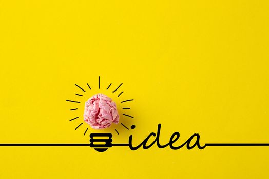 Creative idea, Inspiration, New idea and Innovation concept with Crumpled Paper light bulb on yellow background.