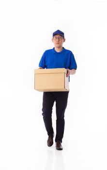 young Asian delivery man in blue uniform, carrry cardboard box in hands isolated on white background. Delivery concept