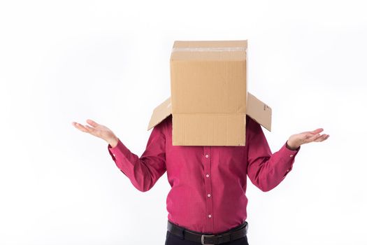 man in a red shirt with a cardboard box on his head makes a gesture with his hands isolated on white background