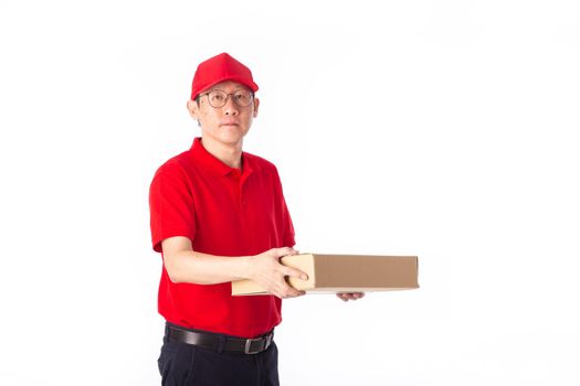 young Asian delivery man in red uniform, carry cardboard box in hands isolated on white background. Delivery Concept
