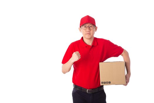 young Asian delivery man in red uniform, carry cardboard box in hands isolated on white background. Delivery Concept