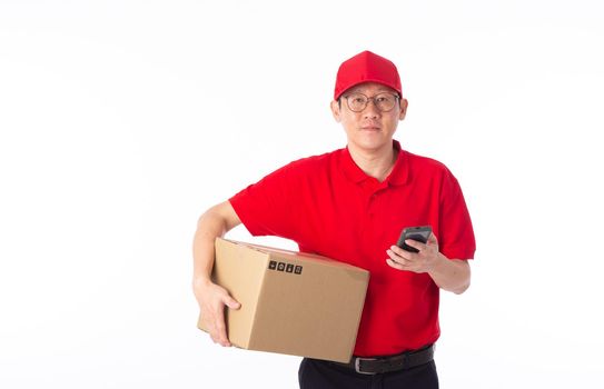 young Asian delivery man in red uniform, carry cardboard box in hands isolated on white background. Delivery Concept