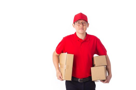 young Asian delivery man in red uniform, carry cardboard box in hands isolated on white background. Delivery Concept