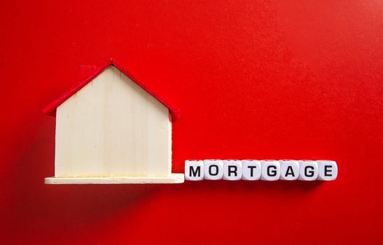Property investment and house mortgage financial concept, Wooden house with mortgage word
